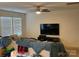 Relaxed living room featuring a ceiling fan, large windows and comfortable seating at 211 Hidden Lakes Rd, Statesville, NC 28677