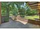 Backyard brick patio featuring a gate, brick seat, and string lights, creating a cozy outdoor space at 2301 Seth Thomas Rd, Charlotte, NC 28210