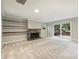 Spacious basement featuring a stone fireplace, built-in shelving, and sliding glass doors to the backyard at 2301 Seth Thomas Rd, Charlotte, NC 28210
