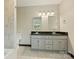 Bathroom with a double sink vanity with black countertops, and a window offering natural light at 2301 Seth Thomas Rd, Charlotte, NC 28210