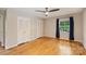 Bright bedroom with hardwood floors, a ceiling fan, and natural light from the window at 2301 Seth Thomas Rd, Charlotte, NC 28210