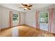 Bedroom with hardwood floors, decorative wallpaper, two windows offering natural light and views at 2301 Seth Thomas Rd, Charlotte, NC 28210