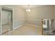 Inviting dining room area with tile floors, updated light fixture, and entry door to the outdoors at 2301 Seth Thomas Rd, Charlotte, NC 28210