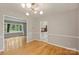 Dining room showcasing hardwood floors and views into the living room and kitchen at 2301 Seth Thomas Rd, Charlotte, NC 28210