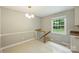 Bright dining room with hardwood-style flooring and light fixture with staircase entry to second level at 2301 Seth Thomas Rd, Charlotte, NC 28210