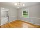 Bright dining room with hardwood floors, trim accents, and a modern light fixture at 2301 Seth Thomas Rd, Charlotte, NC 28210