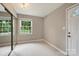 Inviting entryway featuring neutral tile flooring, a window with natural light, and a mirrored closet at 2301 Seth Thomas Rd, Charlotte, NC 28210