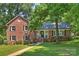 Charming brick home featuring a welcoming front porch and beautifully landscaped front yard at 2301 Seth Thomas Rd, Charlotte, NC 28210