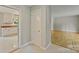 Hallway featuring tile floors, views into the kitchen and hardwood floors in the living spaces at 2301 Seth Thomas Rd, Charlotte, NC 28210
