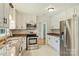 Bright and spacious kitchen with stainless steel appliances, granite countertops and ample white cabinetry at 2301 Seth Thomas Rd, Charlotte, NC 28210
