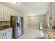 Open floorplan combines kitchen with dining space, stainless appliances, granite counters, and tile floors at 2301 Seth Thomas Rd, Charlotte, NC 28210
