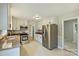 Well-lit kitchen with stainless steel appliances, granite countertops, white cabinetry, and tile floors at 2301 Seth Thomas Rd, Charlotte, NC 28210