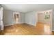 Open-concept living room featuring hardwood floors and views into the dining room and hallway at 2301 Seth Thomas Rd, Charlotte, NC 28210