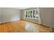 Bright living room featuring hardwood floors and a large window overlooking the front yard at 2301 Seth Thomas Rd, Charlotte, NC 28210