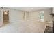 Spacious living room with neutral carpet, a fireplace, and multiple entryways to other parts of the home at 2301 Seth Thomas Rd, Charlotte, NC 28210