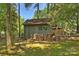 Backyard shed surrounded by mature trees, offering ample storage space with room for firewood at 2301 Seth Thomas Rd, Charlotte, NC 28210