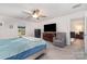Spacious bedroom featuring a ceiling fan, large dresser with a TV, recliner and an ensuite bathroom at 2317 Trollinger Dr, Catawba, NC 28609
