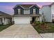 Charming two-story home featuring blue and gray siding, a two-car garage, and well-maintained landscaping at 2317 Trollinger Dr, Catawba, NC 28609