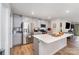 Modern kitchen with stainless steel appliances, gray cabinets, island, and a view to the living area at 2317 Trollinger Dr, Catawba, NC 28609
