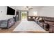 Living room with a large brown sofa, neutral rug, and a sliding glass door to the outside at 2317 Trollinger Dr, Catawba, NC 28609