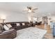 Living room with a large brown sofa, neutral rug, and open access to the dining room and kitchen at 2317 Trollinger Dr, Catawba, NC 28609