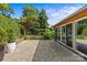 Spacious backyard featuring lush greenery, stone ground cover, and outdoor seating at 2424 Cumberland Ave, Charlotte, NC 28203