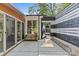 Backyard patio featuring black and white fencing, walkway, and an entry into the sunroom at 2424 Cumberland Ave, Charlotte, NC 28203