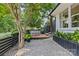 Backyard deck with a cozy dining set, perfect for outdoor entertaining, surrounded by trees and greenery at 2424 Cumberland Ave, Charlotte, NC 28203