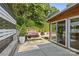 Backyard featuring a stone retaining wall, lush landscaping, and a cozy outdoor seating area at 2424 Cumberland Ave, Charlotte, NC 28203
