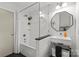 Well-lit bathroom with white subway tile, glass shower screen, unique vanity, and modern fixtures, creating a clean and stylish space at 2424 Cumberland Ave, Charlotte, NC 28203