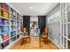 Dining room featuring custom built-in bookshelves, a stylish glass table, and ample natural light at 2424 Cumberland Ave, Charlotte, NC 28203