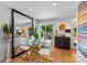 Elegant dining room featuring a modern glass table, sleek chairs, and large mirror at 2424 Cumberland Ave, Charlotte, NC 28203