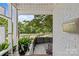 View of the front yard from a porch, with modern fencing and lush greenery, showcasing the property's curb appeal at 2424 Cumberland Ave, Charlotte, NC 28203