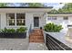 Inviting front entrance of a brick home with well-maintained landscaping and modern accents at 2424 Cumberland Ave, Charlotte, NC 28203