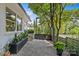 Scenic view of the front yard featuring a well-manicured landscape with modern fencing and a stone walkway at 2424 Cumberland Ave, Charlotte, NC 28203