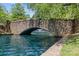 Picturesque stone bridge over a tranquil pond with a fountain in the background at 2424 Cumberland Ave, Charlotte, NC 28203