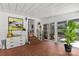 Sunroom with brick steps, red tile floor, access to the backyard, and bright natural light at 2424 Cumberland Ave, Charlotte, NC 28203