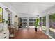 Bright sunroom with tile floor, large windows, and sliding door access to the outdoor patio space at 2424 Cumberland Ave, Charlotte, NC 28203