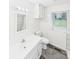 Bright bathroom featuring a single sink vanity, toilet, and tiled shower/tub combo with a window view at 271 Nc 16 N Hwy, Taylorsville, NC 28681