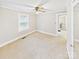 Neutral carpeted bedroom featuring natural lighting and a view into another room at 271 Nc 16 N Hwy, Taylorsville, NC 28681