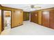 Carpeted bedroom with wood paneling, open access to a bathroom and closet space at 271 Nc 16 N Hwy, Taylorsville, NC 28681
