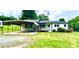 Ranch-style home with white siding, a covered carport, front porch, and mature trees in the front yard at 271 Nc 16 N Hwy, Taylorsville, NC 28681