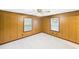 Living room featuring wood paneling, two windows, and neutral carpet at 271 Nc 16 N Hwy, Taylorsville, NC 28681