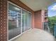 Spacious brick balcony with sliding glass doors and views of the community at 300 W 5Th St # 339, Charlotte, NC 28202