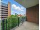 Outdoor balcony surrounded by tall buildings and a skyline in the distance at 300 W 5Th St # 339, Charlotte, NC 28202
