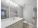 Bathroom features a large mirror, vanity, and shower with modern fixtures at 300 W 5Th St # 339, Charlotte, NC 28202