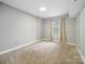 Carpeted bedroom with neutral walls and a window letting in natural light at 300 W 5Th St # 339, Charlotte, NC 28202