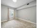 Cozy carpeted bedroom with neutral walls and a window with light-filtering curtains at 300 W 5Th St # 339, Charlotte, NC 28202