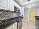 Cozy kitchen featuring stainless steel appliances, white cabinets, and granite countertops at 300 W 5Th St # 339, Charlotte, NC 28202