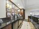 Kitchenette features dark cabinetry, backsplash, mirror accents, and stainless steel appliances at 300 W 5Th St # 339, Charlotte, NC 28202